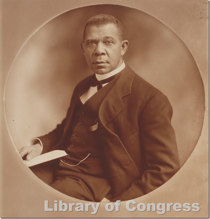 Booker T. Washington in coat and vest holding a book