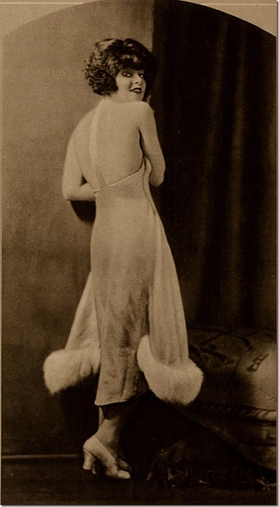Clara Bow in fur-trimmed outfit with bare back