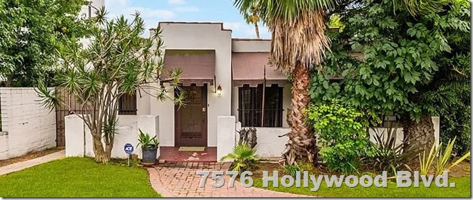Clara Bow's 1920s house, with a brick sidewalk and palm tree in front. 